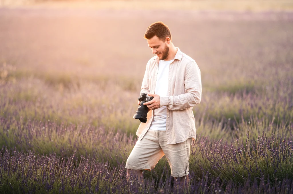 Photographe préparant une séance photo en extérieur.